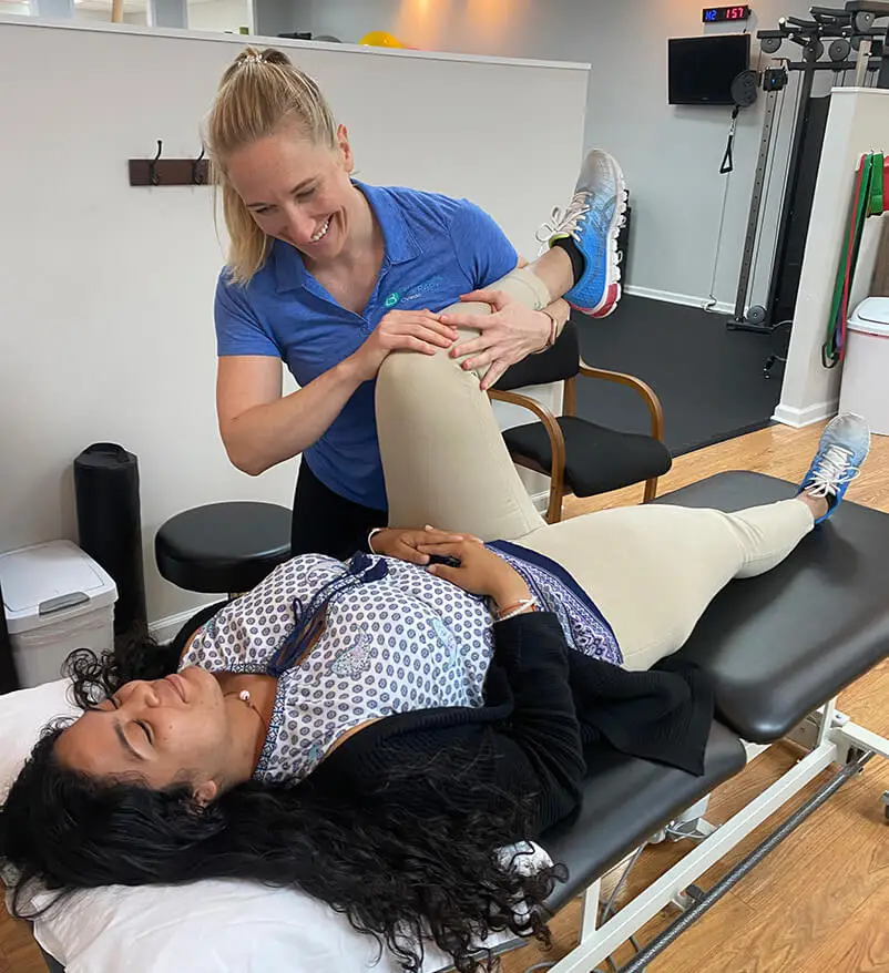 Physical therapist assessing woman's physical health